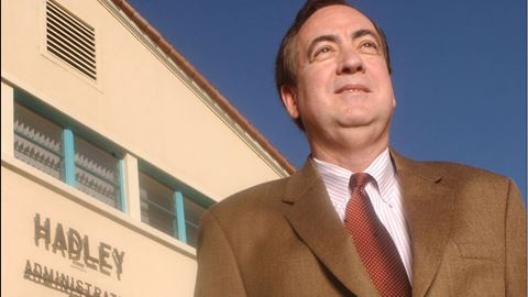 A 2002 portrait of Jay Gogue in front of Hadley Hall