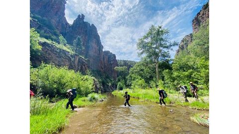 A group of students crossing a river