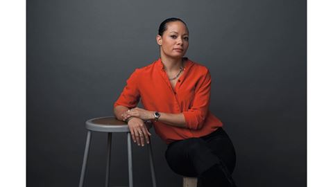 A woman leaning on a chair