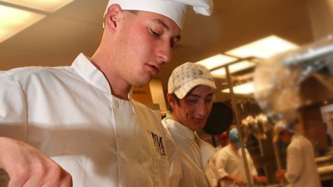 Photo of HRTM students cooking vegetables during food preparation class