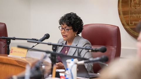 Woman speaking into microphone