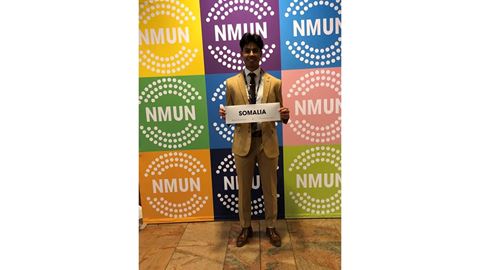 Male student holding a sign