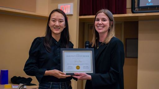 IMAGE DESCRIPTION Two women holding a plaque