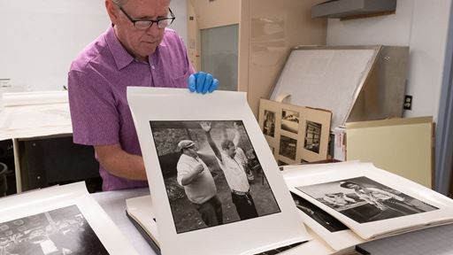 Photo of Dennis Daily department head of NMSU Archives sharing Sterling Trantham s photos in collections