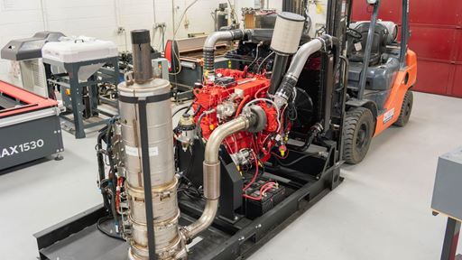 Description A large diesel engine with computer controls in a machine shop