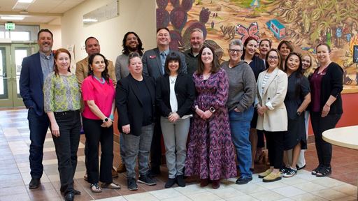 IMAGE DESCRIPTION A photo of a group of people standing in a lobby