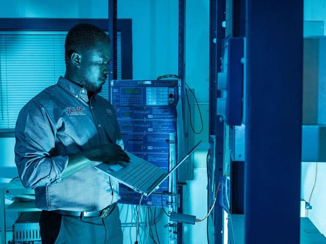 IMAGE DESCRIPTION Man standing next to electrical equipment