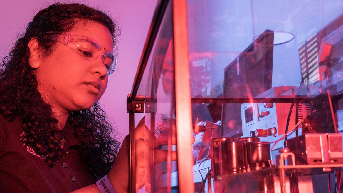 IMAGE DESCRIPTION Woman standing next to electrical equipment