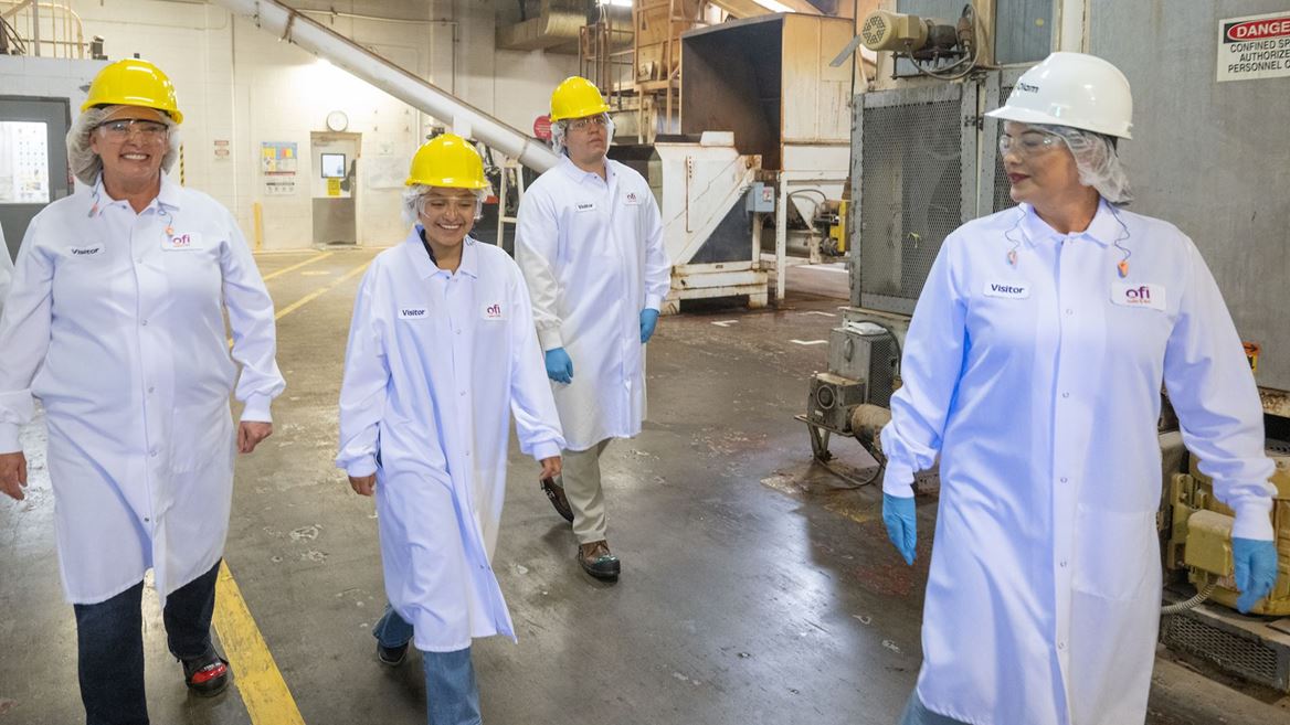 Photo of students and staff touring Olam Food Ingredients production facility