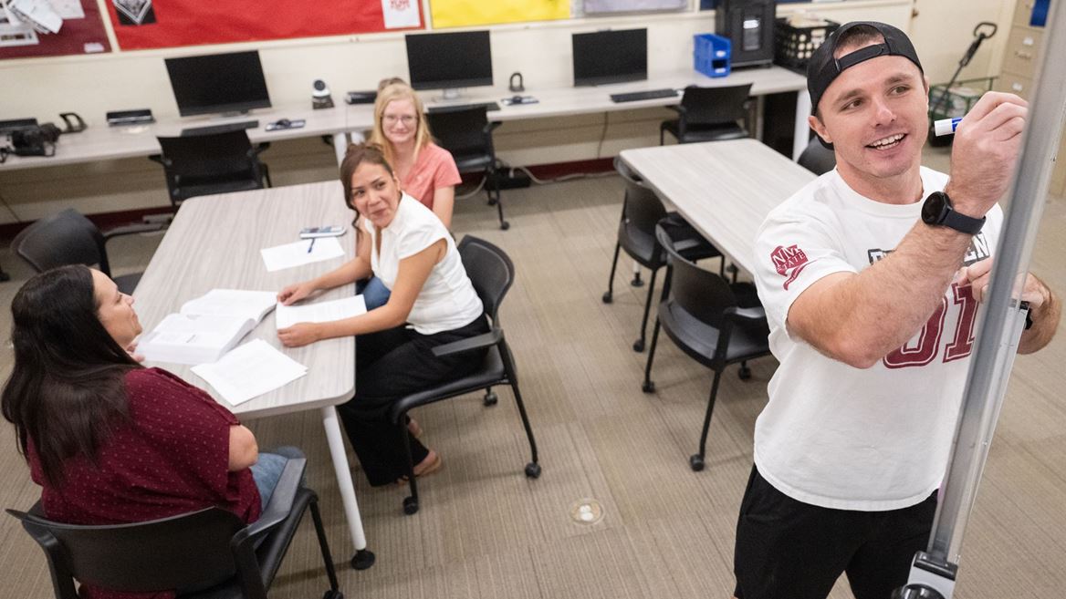 Photo of Blade Morris giving instruction to Adult Education students at the NMSU Grants campus