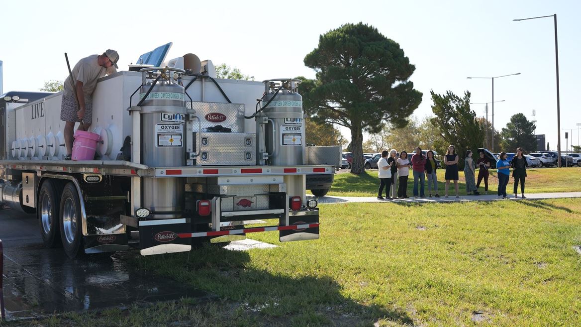 Photo of first fish stocking at Alumni Pond