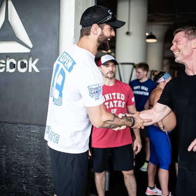 Reebok CrossFit trainer Conor Murphy shakes hands with Chris Irwin, Navy SEAL Foundation, at Reebok’s Boston HQ.
