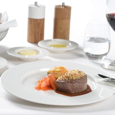 Main course in First Class bison tenderloin with hazelnut crumble