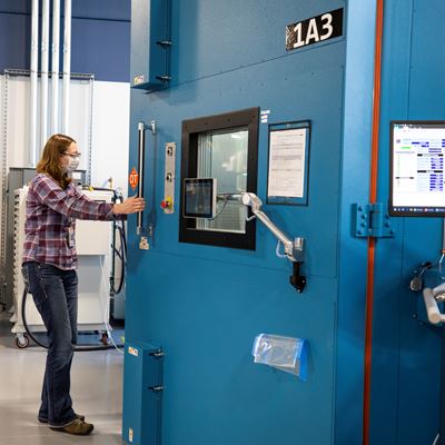 Mary Fredrick, Ford Motor Co. battery validation engineer, opens the doors to a thermal chamber used to soak batter...