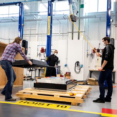 Ford Motor Co. engineers remove a battery cover to access internal components like cell arrays, wiring and contactor...