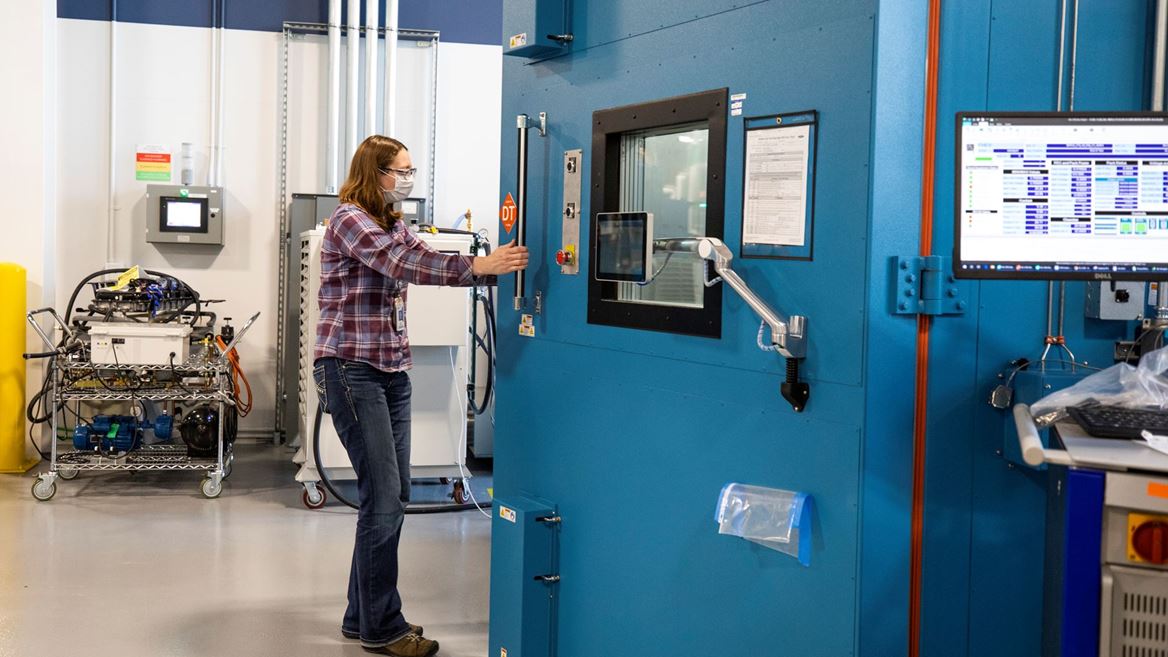 Mary Fredrick, Ford Motor Co. battery validation engineer, opens the doors to a thermal chamber used to soak batter...