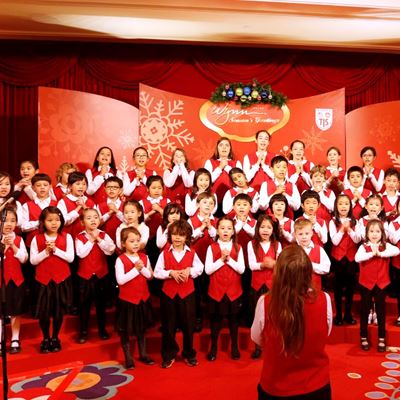 A cheerful group of 54 primary students from the TIS Crescendo Choir caroling at the lobby of Wynn Macau