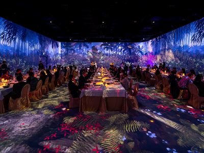 Guests attend the Illuminarium immersive gala dinner at Wynn