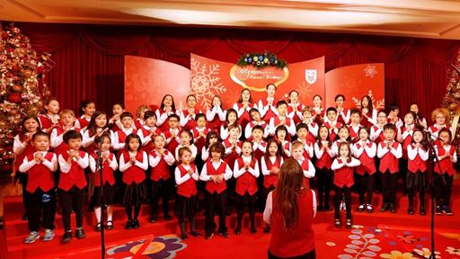 A cheerful group of 54 primary students from the TIS Crescendo Choir caroling at the lobby of Wynn Macau