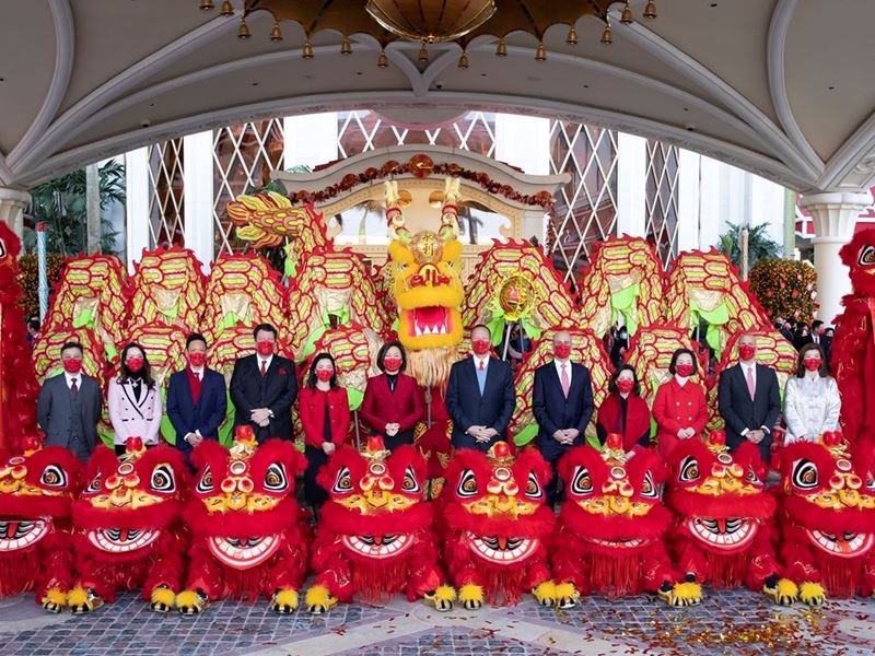 The Wynn management team poses for a group photo with colorful dragon and lions at Wynn Palace after the ceremony.