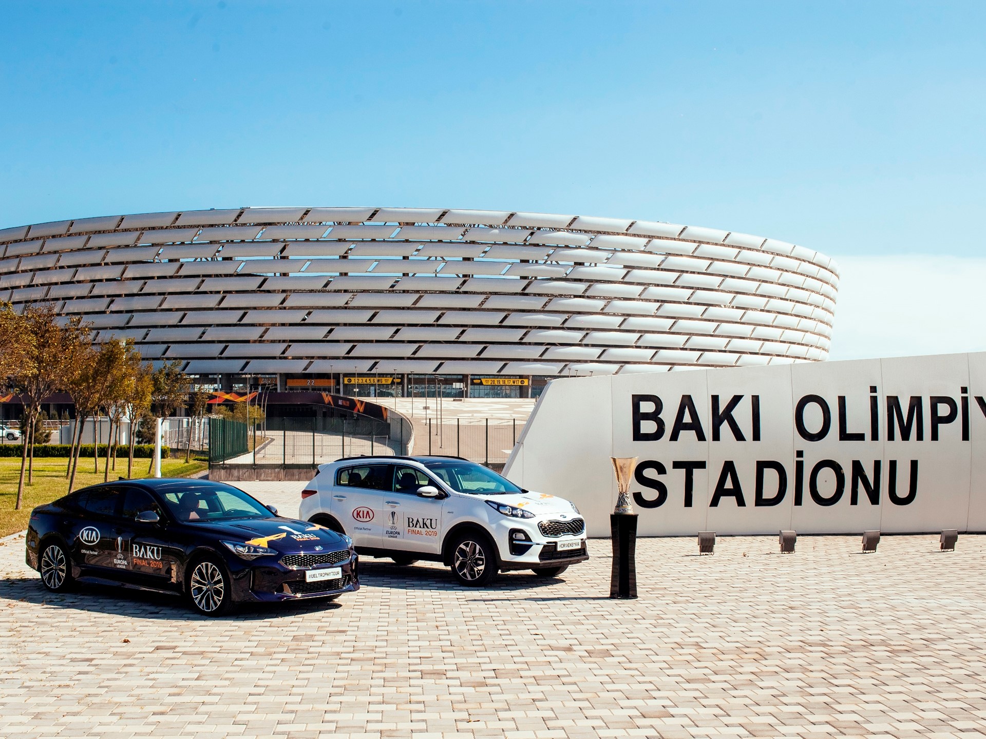 Kia Stinger (left) and Kia Sportage models in front of Baku Olympic Stadium