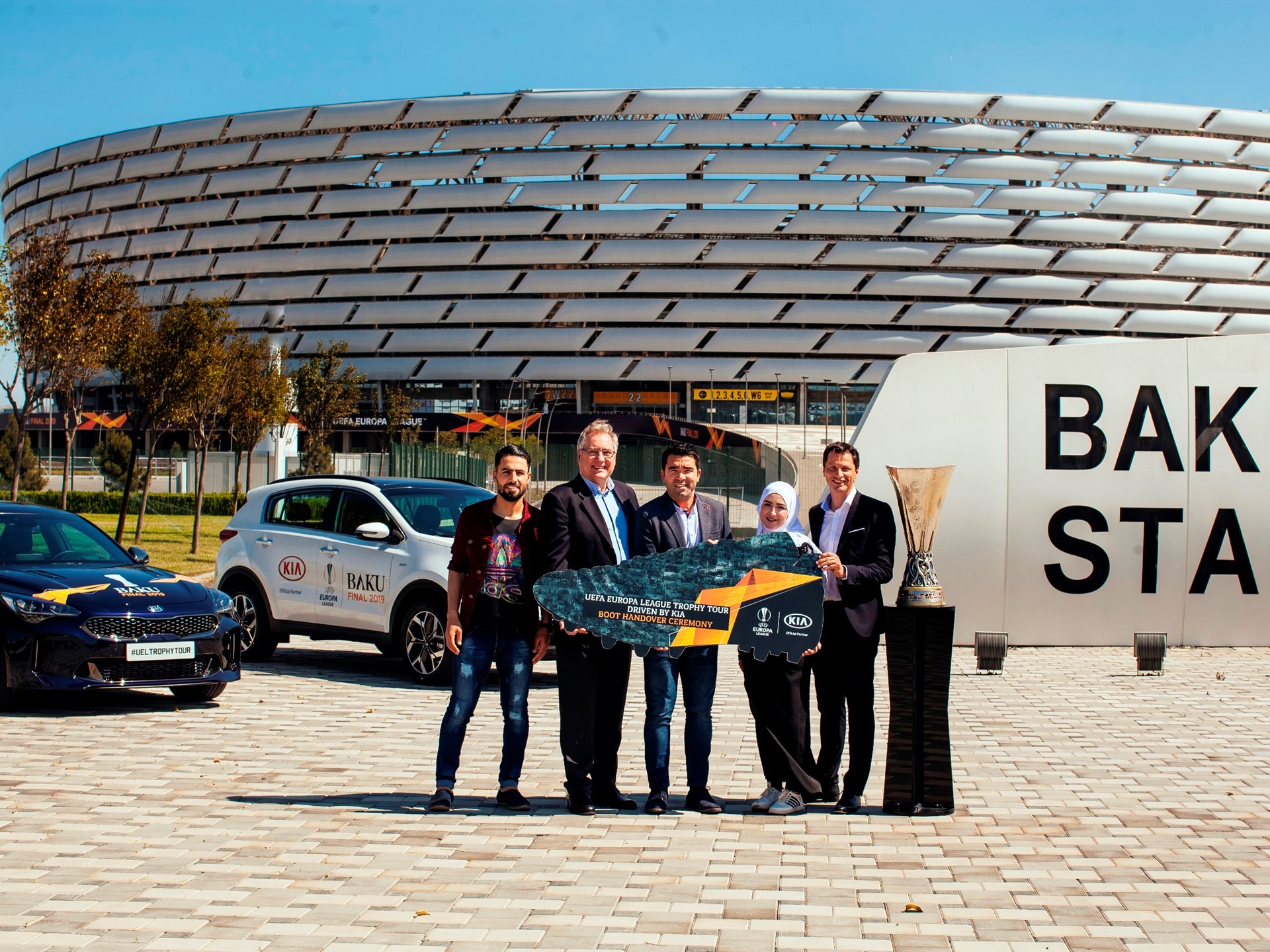 Participants pose at a handover ceremony of football boots to Jordan’s Za’atari Refugee Camp