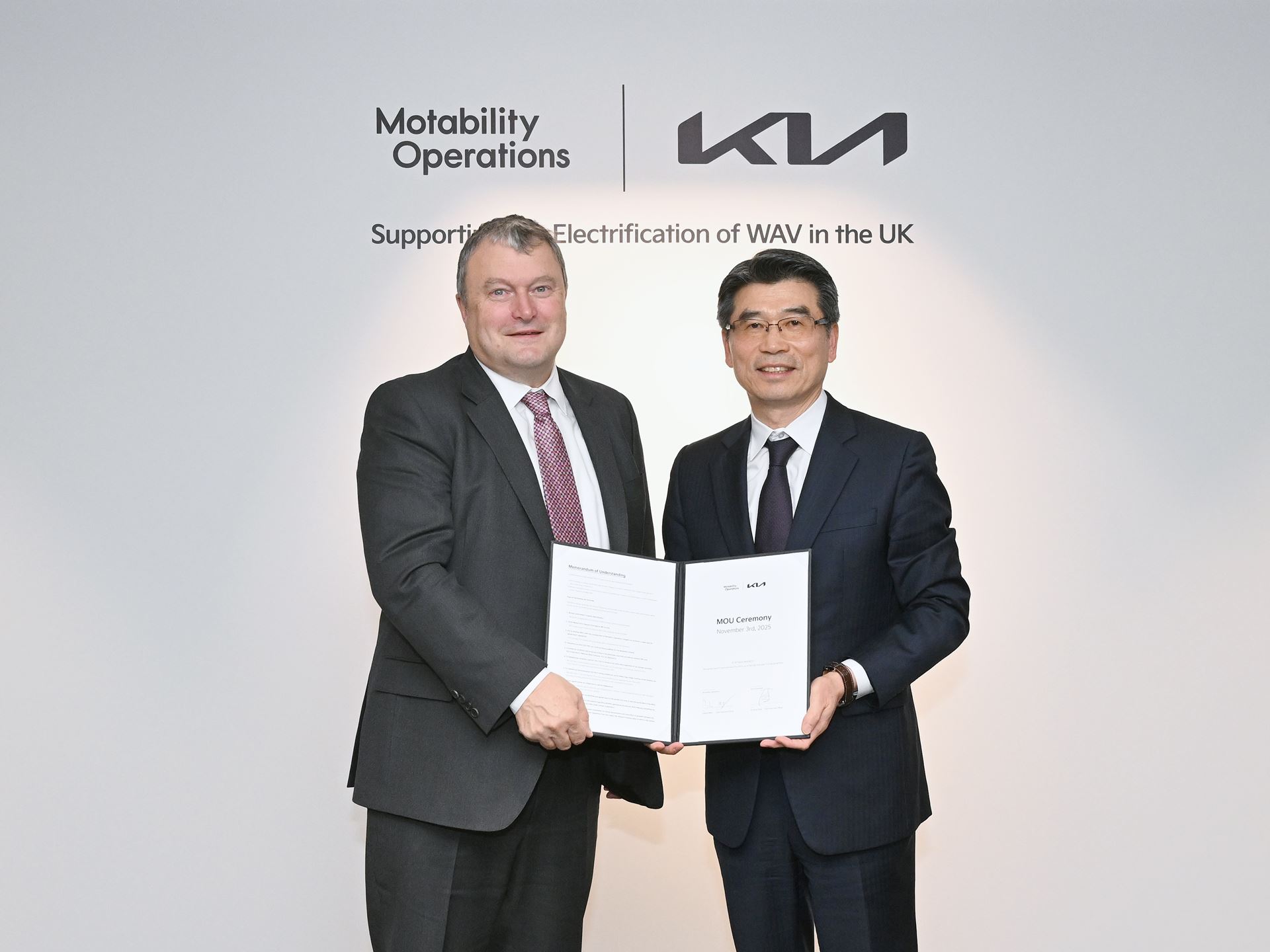 from left Andrew Miller CEO of Motability Operations and Ho Sung Song President and CEO of Kia Corporation