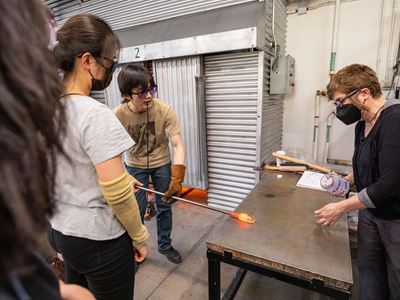 Dongheng Yang MFA 24 GL and Glass faculty member Jocelyne Prince MFA 94 GL at work in the Experiments in Optics studio.