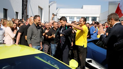 M. Renzi receives the Automobili Lamborghini uniform from a Lamborghini blue collar