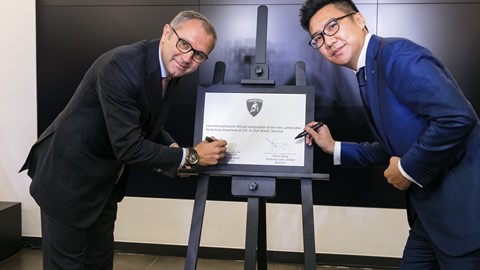 Mr. Stefano S. Domenicali and A. Wong sign the commemoration plaque